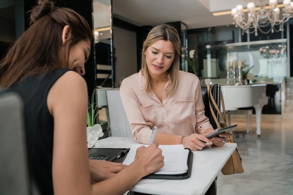 portrait-of-two-young-businesswomen-having-meeting