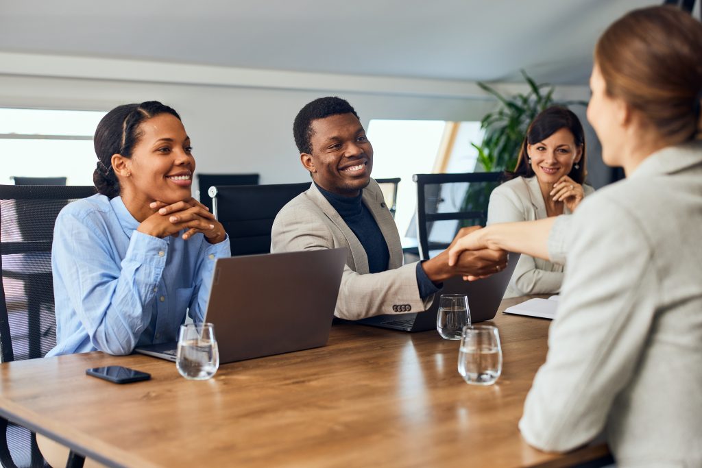 Business colleagues having a meeting at the office, doing a handshake.